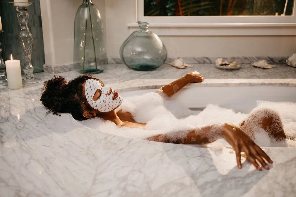 Woman enjoying a relaxing hydrogel face mask during a cozy at-home spa moment